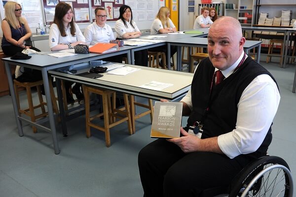 John B client showing teacher award