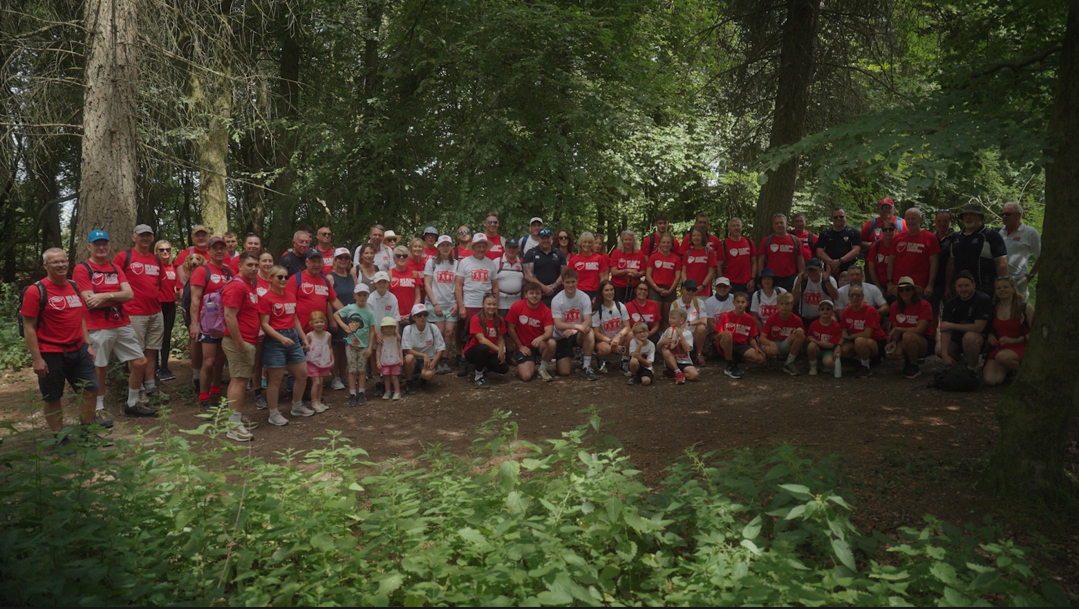 Group of people in IPF shirts standing in woods