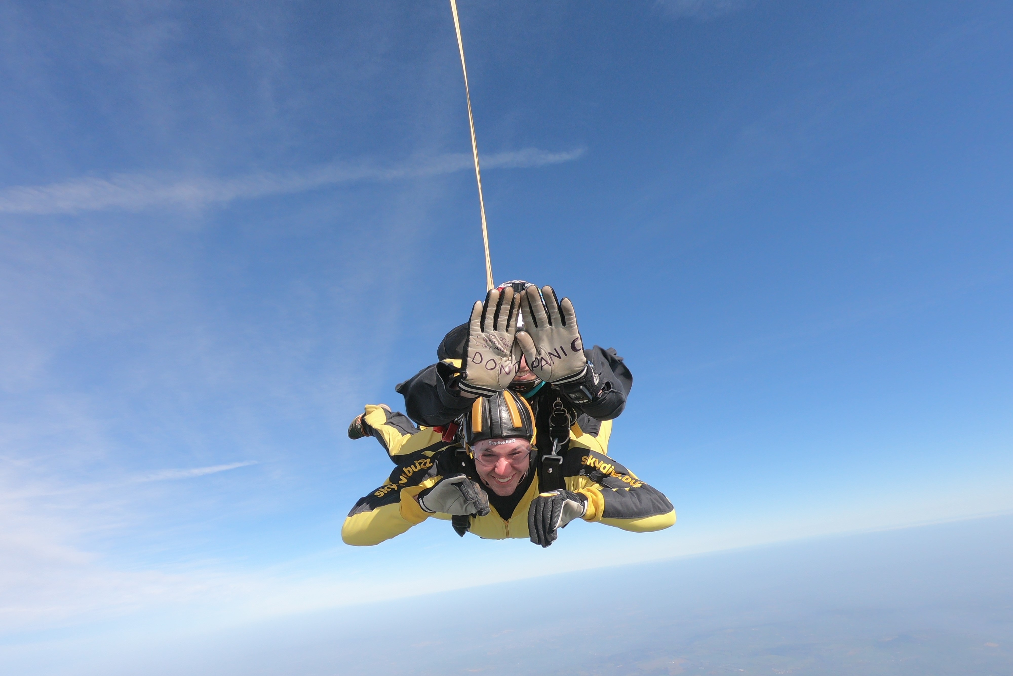 People engaged in a tandem skydive