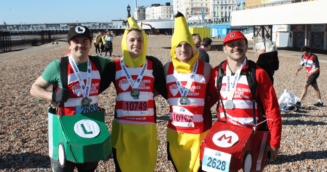 4 people in fancy dress and RFU Injured Players Foundation tops